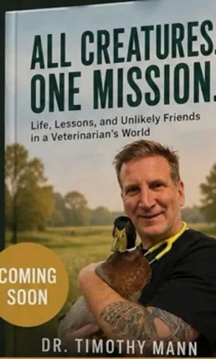 Cover of All Creatures. One Mission. by Dr. Timothy Mann, showing him holding a duck